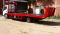 Transporte en tráiler planchón cama alta en Kingston, Jamaica